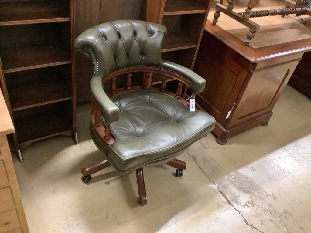 A reproduction captain's chair, width 64cm, depth 58cm, height 84cm